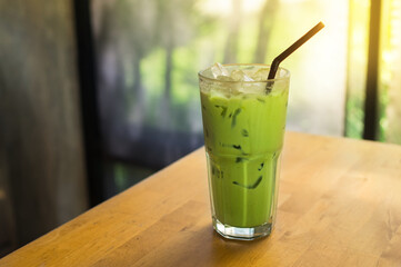 Ice green tea glass on wooden table.