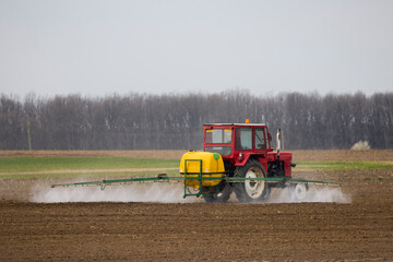 an agricultural machine that spreads herbicide on a field