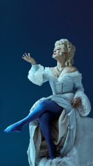 Obraz premium Dramatic poise. Medieval elegant woman in white dress lifts leg mid-gesture with expressive flair, frozen in noble confidence. Concept of historical portrait, medieval times, character.
