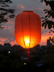 Obraz premium Illuminated lantern against a colorful sunset