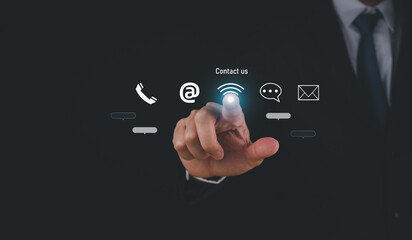 A business professional interacts with digital contact icons, highlighting communication options like phone, email, and messaging in a modern setting.