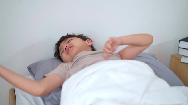 Asian boy looks drowsy after just waking up in the morning.