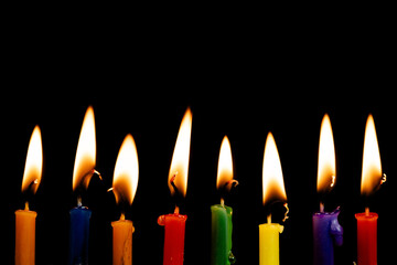 Burning church candles against a dark background