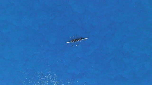Abstract aerial video of rowing boat.