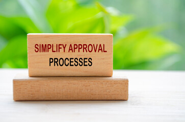 Simplify Approval Processes text on wooden blocks representing continuous Improvement approach