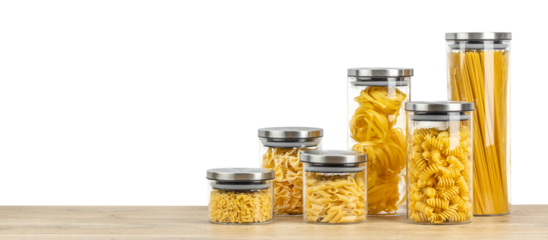 Assortment raw pasta in a glass jars isolated on white background. Long banner format. copy space