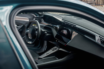 Modern car interior featuring dashboard, steering wheel and screen