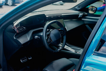 Modern car interior featuring dashboard, steering wheel and screen
