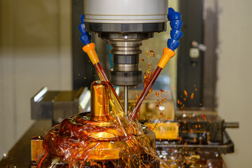 The CNC milling machine finishing cut the brass shell mold with oil coolant method.