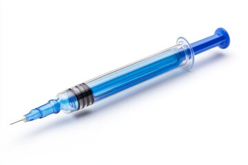 Detailed close-up of a medical syringe filled with blue liquid placed on a clean white surface in a well-lit environment
