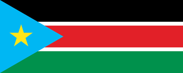 National flag of South Sudan waving against a bright blue sky in a peaceful setting