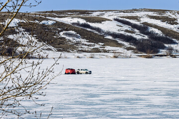 Lonely ice fishing shack in late March at Blackstrap Lake, Saskatchewan, Canada