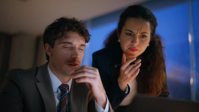 Professional trainer teaching intern dissatisfied work in evening office closeup