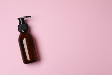 Natural cosmetic products. Cosmetic bottle on a pink background, top view