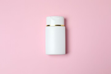 Natural cosmetic products. Cosmetic bottle on a pink background, top view