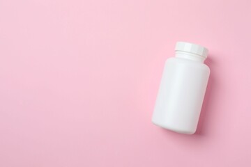 White bottle on color background, top view