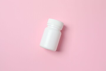 White bottle on color background, top view