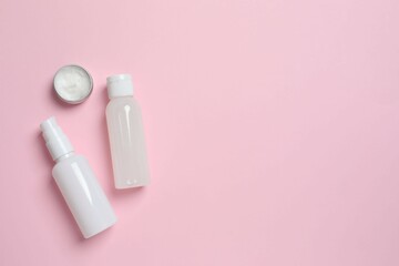 Natural cosmetic products on a pink background, top view