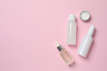 Natural cosmetic products on a pink background, top view