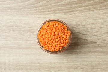 Red lentils on a wooden background