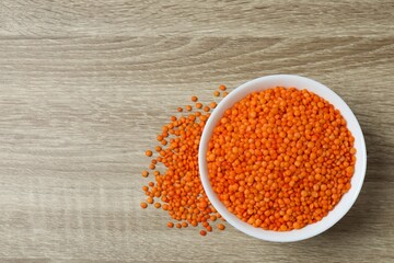 Red lentils on a wooden background