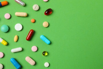 Various pills on color background, top view