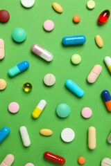Various pills on color background, top view