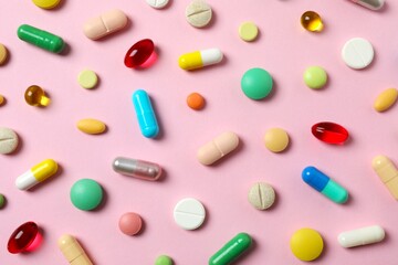 Various pills on color background, top view