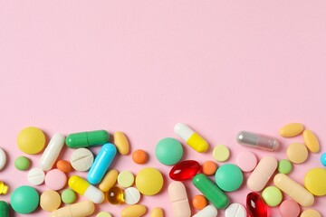 Various pills on color background, top view