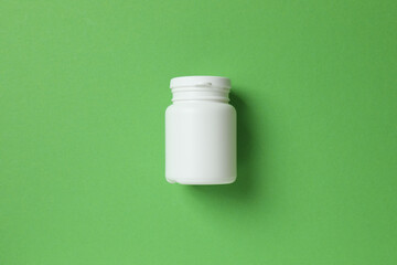 White bottle on color  background, top view