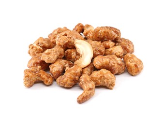 Heap of caramelized cashew nuts on white background.