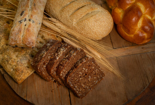 Overhead view of different breads on wooden cutting board