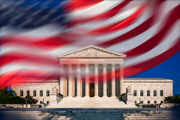 Supreme Court building and blurred American flag against blue sky