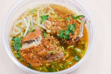 Pork tom yum noodles in a bowl on the table