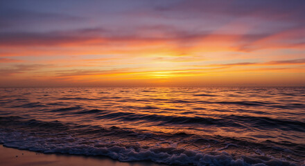 Obraz premium Serene sunset over calm ocean waves at the beach 