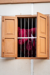 kāṣāya, kesa, traditional Buddhist monastic robe hanging out to dry at the window.