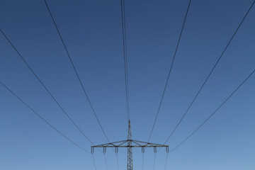 Electricity pylon on an overland route in Germany against a blue sky