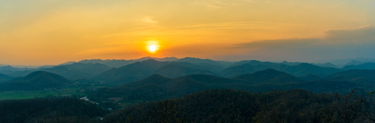 Golden sunset over forested hills in Mae Hong Son, Thailand