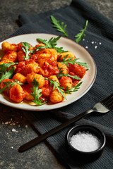 Traditional italian gnocchi with tomato sauce. Vertical photograph