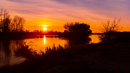 Fototapeta premium Sunset with reflections near Straubing, Danube, Straubing-Bogen, Bavaria, Germany