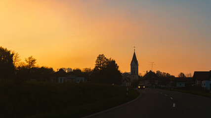 Sunset with a church silhouette near Wallerfing, Deggendorf, Bavaria, Germany