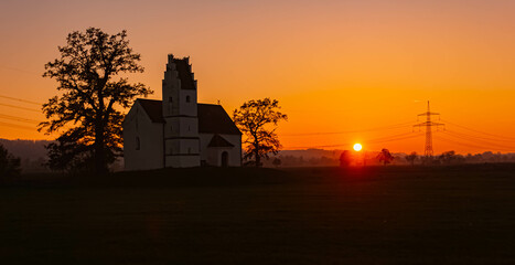 Sunset with a church silhouette near Huett, Eichendorf, Dingolfing-Landau, Bavaria, Germany