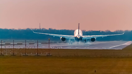 Passenger jet airplane on a sunny summer sunset at Munich airport, MUC, Freising, Bavaria, Germany
