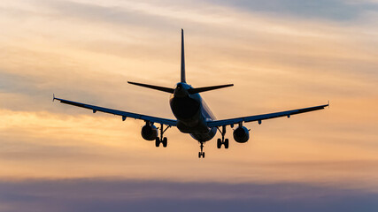 Passenger jet airplane on a sunny summer sunset at Munich airport, MUC, Freising, Bavaria, Germany