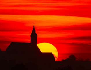 Megazoom (600mm) sunset with a church silhouette near Arbing, Osterhofen, Deggendorf, Bavaria,...