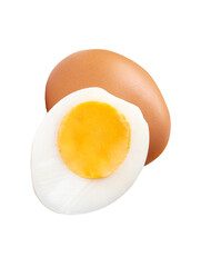 Front view of raw brown chicken egg and cooked or boiled chicken egg with egg yolk in half in small pile isolated on white background with clipping path