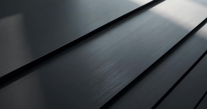 Brushed metal surface in low light with subtle grain illumination.