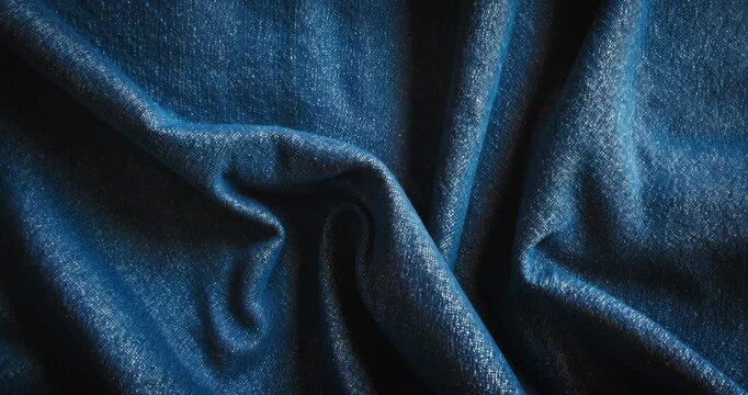 Blue jean fabric. Blank denim textile background. Soft material. Flat cotton texture. Grunge design structure. Dark fabric. Vintage aesthetic.