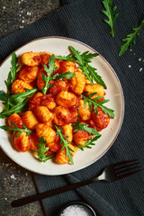 View from above on traditional italian gnocchi in tomato sauce