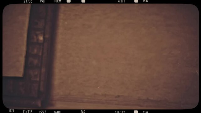 Vintage film reel style with a sepia tone and grainy texture, viewed from a straight-on camera angle, reminiscent of old video footage.